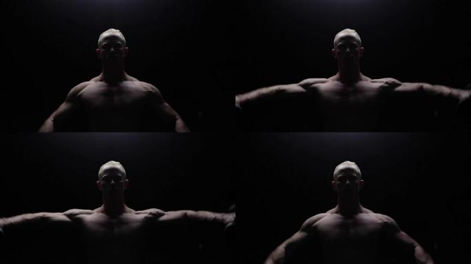 Shirtless bodybuilder workout in dark