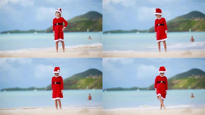 圣诞节假期在白色海滩上戴着圣诞帽的可爱女孩