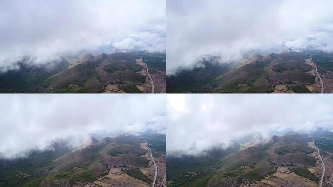 The clouds float above the mountains in the vicini