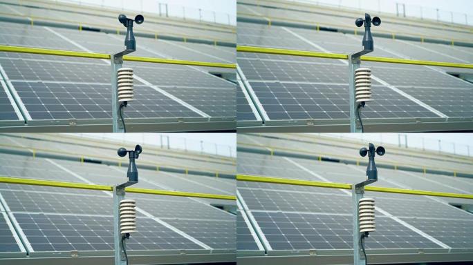 用于测量风速背景太阳能电池的气象站。