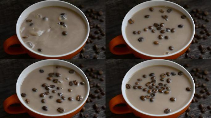 咖啡豆掉进一杯加牛奶的咖啡里