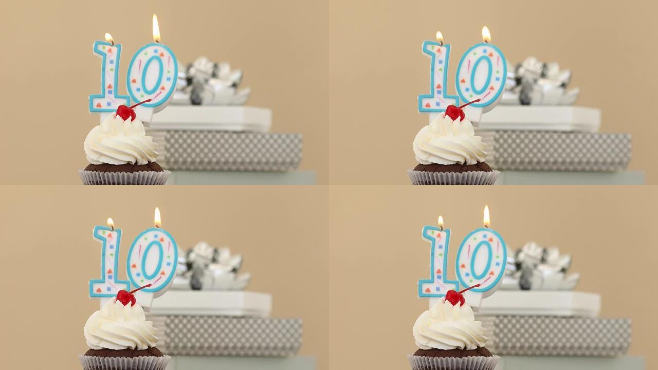 纸杯蛋糕粉彩背景中的十支蜡烛