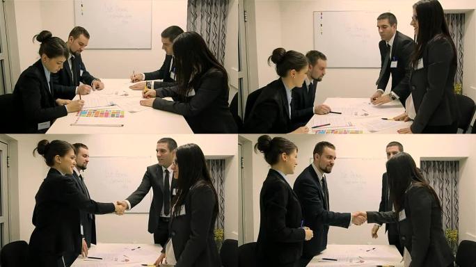 会议或办公室谈判时的商务握手。合伙人对签订合同或财务文件感到满意