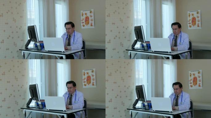 成熟的男人，医生使用电脑
