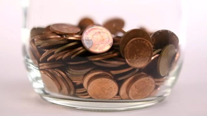 Coins falling into jar - slow motion