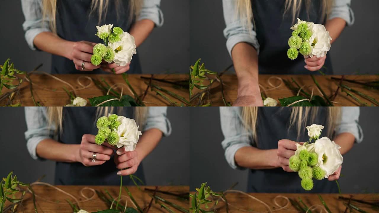 专业金发女花卉艺术家在花店摆放美丽花束的特写镜头。花艺、手工制作和小型企业概念。慢动作镜头