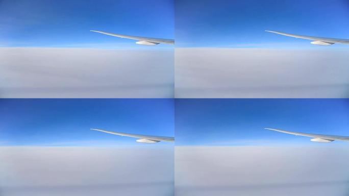飞机的翅膀在蓝天的云层上飞行。