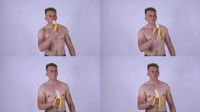 一个年轻性感的男人正在吃香蕉。