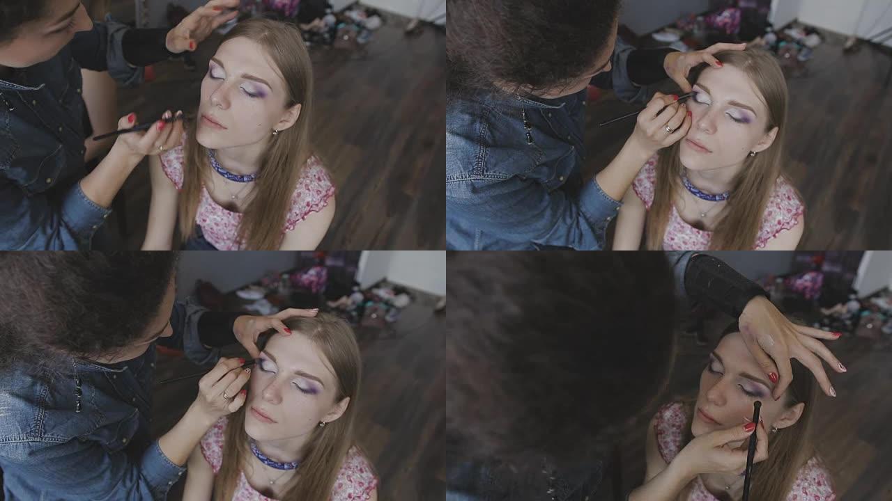 化妆师在照相馆为一个非常漂亮的女孩做专业化妆