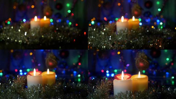 新年蜡烛特写。彩色灯光模糊的背景。将相机从非对焦区域移动到对焦对象。