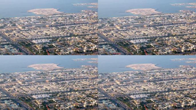 迪拜波斯湾海岸线城市景观的俯视图，小木屋和带车的道路