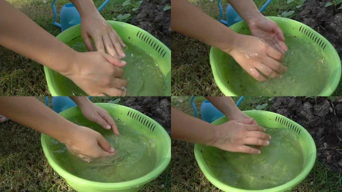 农民在盆子里洗手的慢动作镜头。