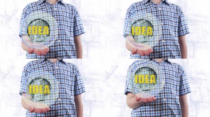年轻人展示了地球和文字想法的全息图