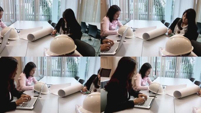 亚洲女企业家和团体使用笔记本为商业伙伴在会议上讨论文件和想法，商业女性为工作而微笑
