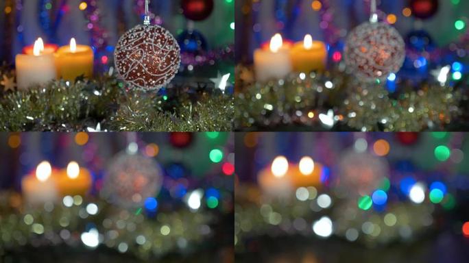一个美丽的红球。新年和圣诞装饰品。闪光花环。背景模糊。摄像机从物体上的移动。