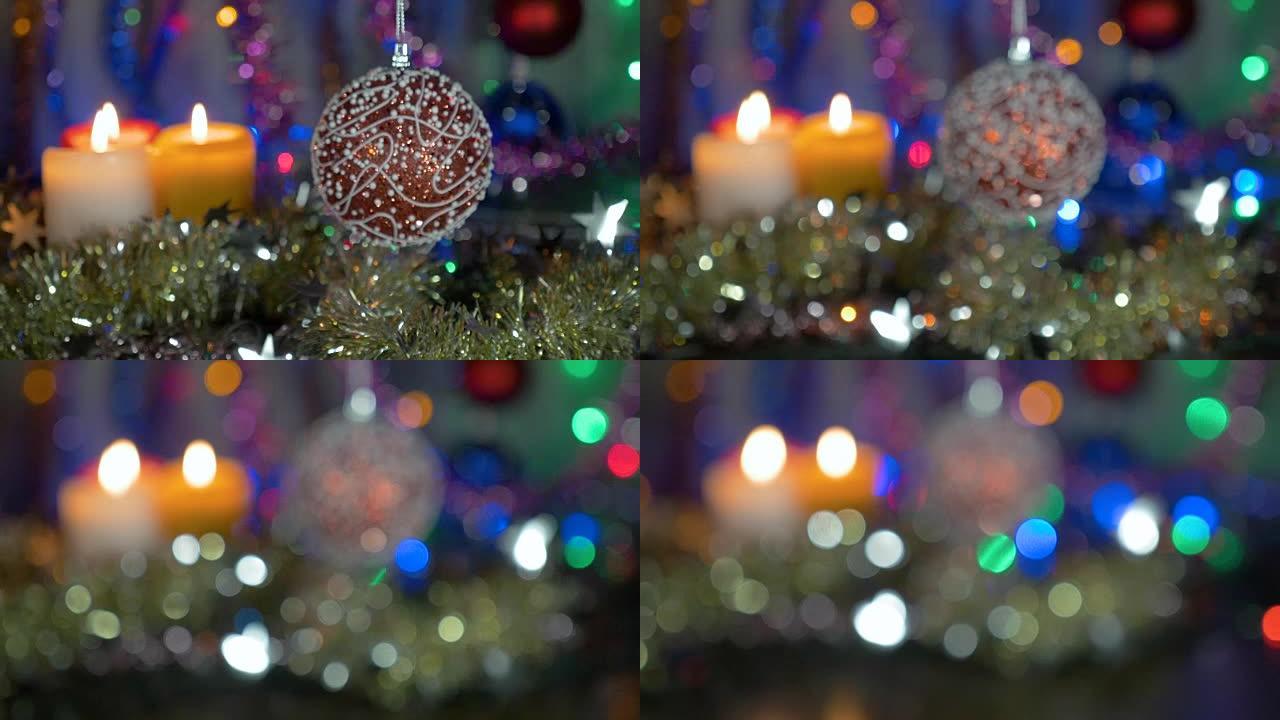 一个美丽的红球。新年和圣诞装饰品。闪光花环。背景模糊。摄像机从物体上的移动。