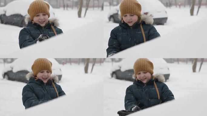 冬天早上，小男孩在户外清洁一辆雪车。