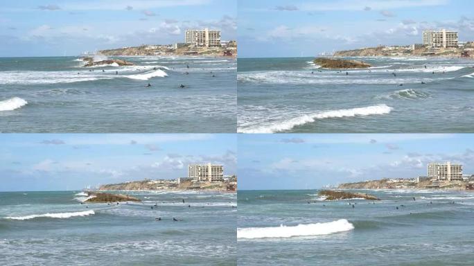 以色列赫兹利亚的海滩、海浪和冲浪者
