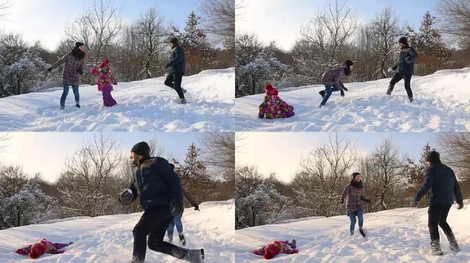 快乐的家庭在雪地里玩得开心