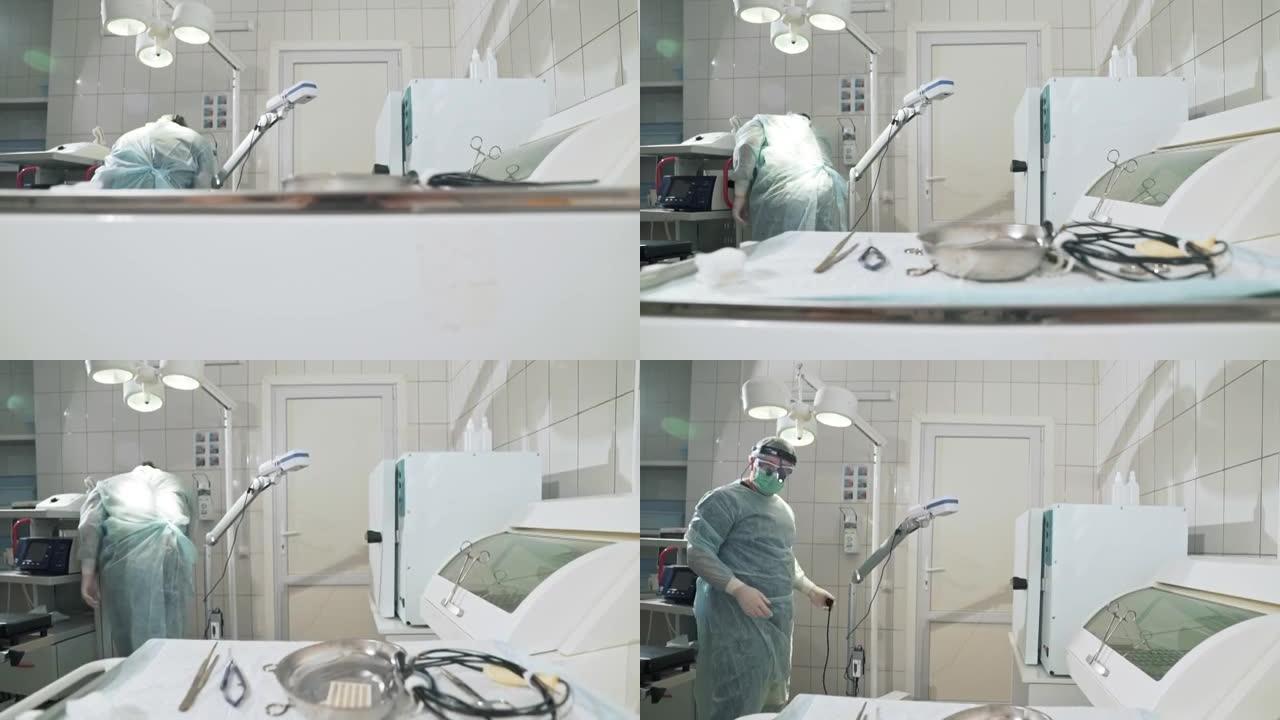 外科医生在医院工作，并在手术前准备医疗器械。戴眼镜、职业装、无菌口罩和睡袍的医生。健康的概念，在诊所