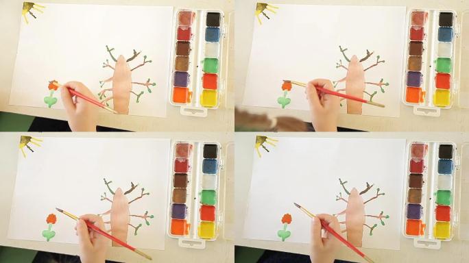 女孩用刷子和油漆画一朵花