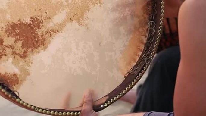 Man playing on a Bongo drum close up. Hand tapping