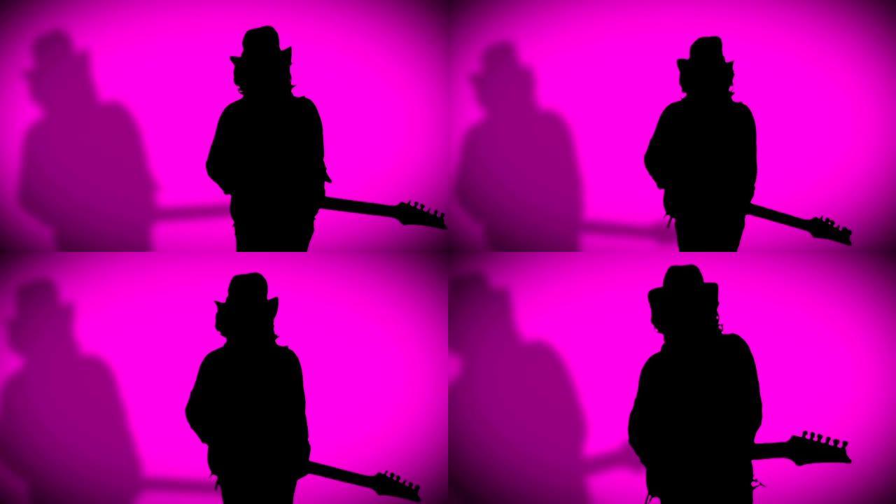 戴着阴影的帽子的酷摇滚吉他手正在粉红色背景上弹奏电吉他。