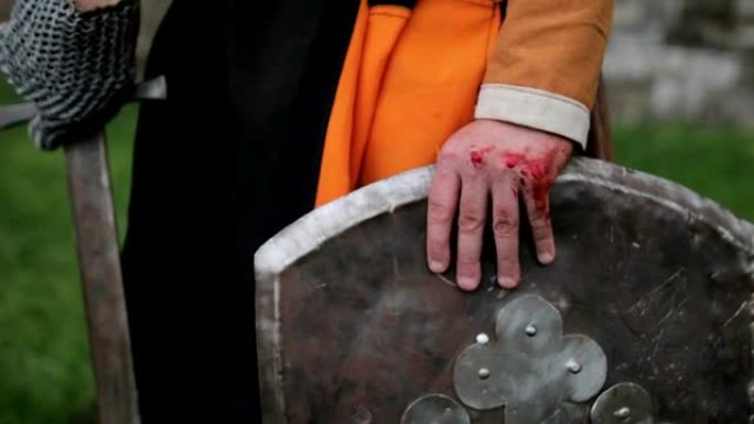 战斗后的中世纪骑士。手臂上有血。真正的伤害