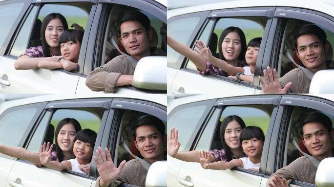 快乐的小女孩和坐在车里享受公路旅行和暑假的亚洲家庭玩尤克里里琴