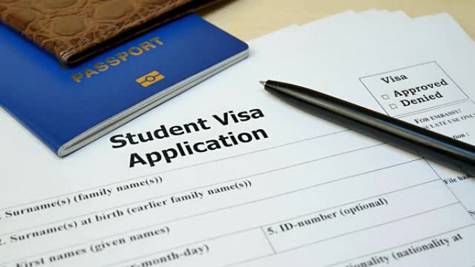 带护照和钢笔的学生签证申请表