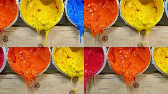 蓝色黄色橙色和红色印花t恤墨水从桶中流出