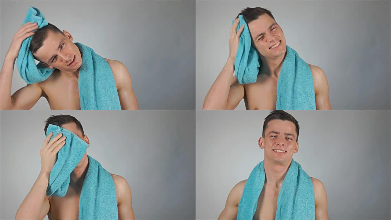 性感的湿家伙擦了蓝色的毛巾。淋浴。