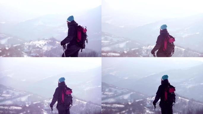 背着背包在山上徒步旅行的人。寒冷的天气，山上下雪。冬季徒步旅行。