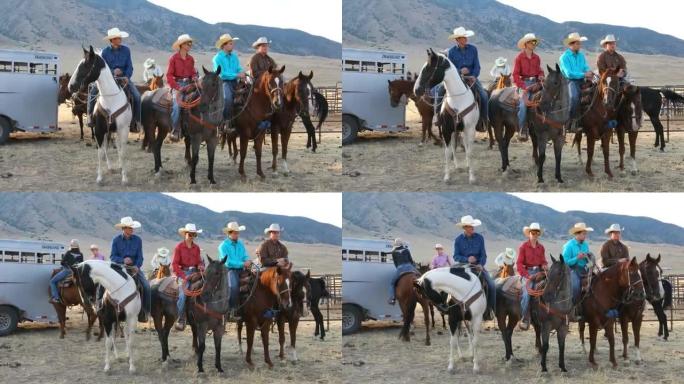 一群骑着马的牛仔和女牛仔