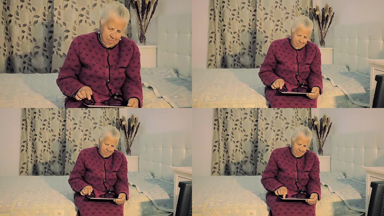 一名八十岁的妇女的特写镜头坐在床上，以慢动作在平板电脑上看着她的照片。