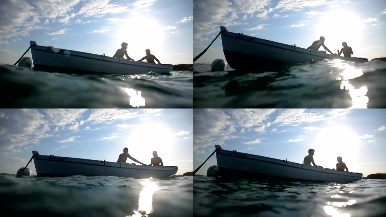 日落时分，一对夫妇在渔船上
