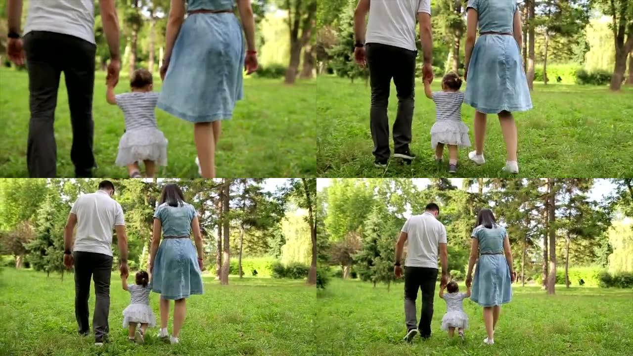 快乐的年轻家庭教宝宝在公园里散步