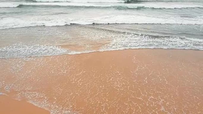 Sea waves over sand beach background