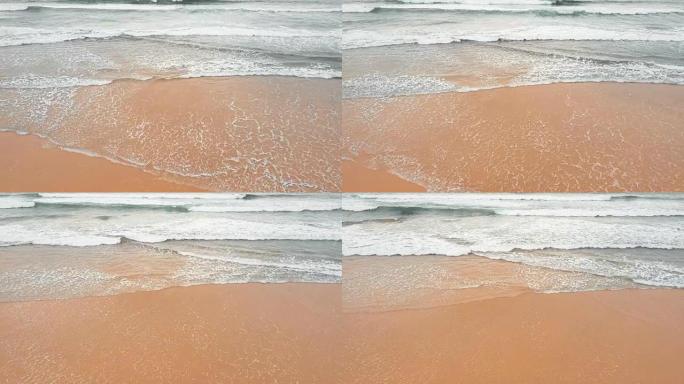 Sea waves over sand beach background