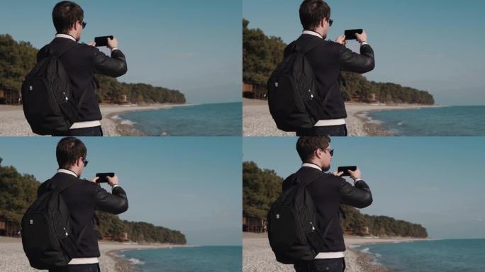 男人在大海的背景上制作了一系列照片，他可以成为游客