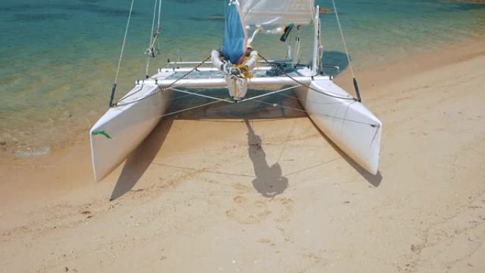 Sail boat, catamaran, on tropical beach with blue 