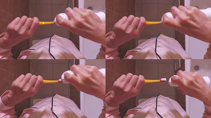 女人在浴室用牙刷挤牙膏