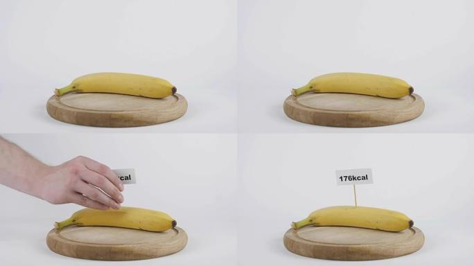 香蕉中的卡路里量，男性手将带有卡路里数量的盘子放在香蕉上，健康营养概念60 fps