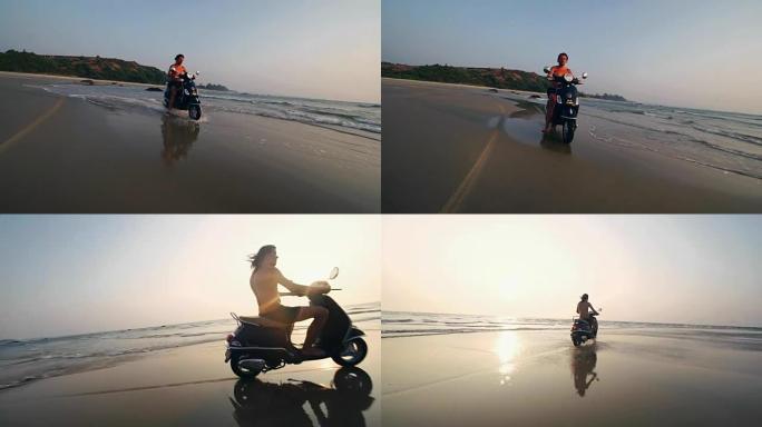 摩托车手在日落时在海滩上驾驶摩托车