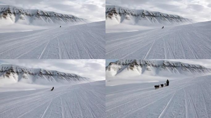北极北极的男子骑狗雪橇队哈士奇爱斯基摩人白雪路。