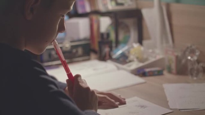 Boy looking at his drawing in deep thaughts