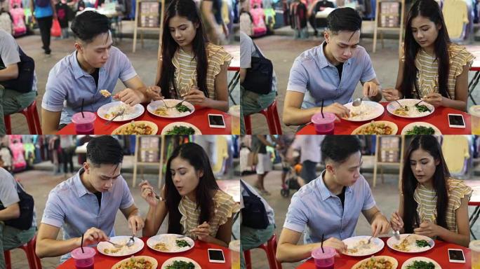夫妇在Jalan Petaling市场享受街头美食