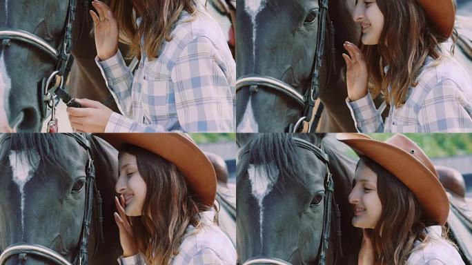 漂亮的年轻女孩走向友好的马，爱抚它的鼻子。慢慢地