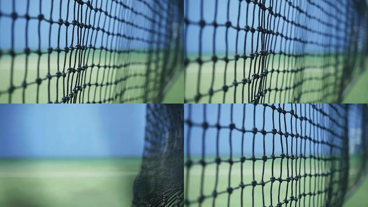 在阳光明媚的日子里，网球的特写镜头以慢动作击中落在网球场上的网格。1920x1080