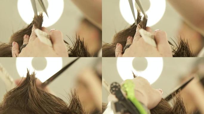 理发手用剪刀和梳子理发。理发店用美发剪刀理发。美容院用梳子近距离理发